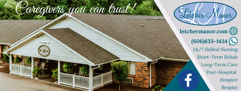 Exterior view of Letcher Manor, a single-story building with a gabled roof and a covered porch with white railings and rocking chairs, surrounded by greenery.