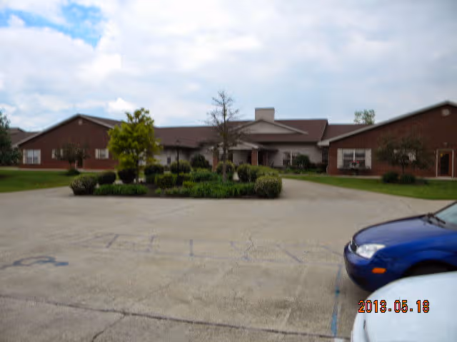Exterior view of Twin Oaks Assisted Living with parking lot and landscaped entrance.