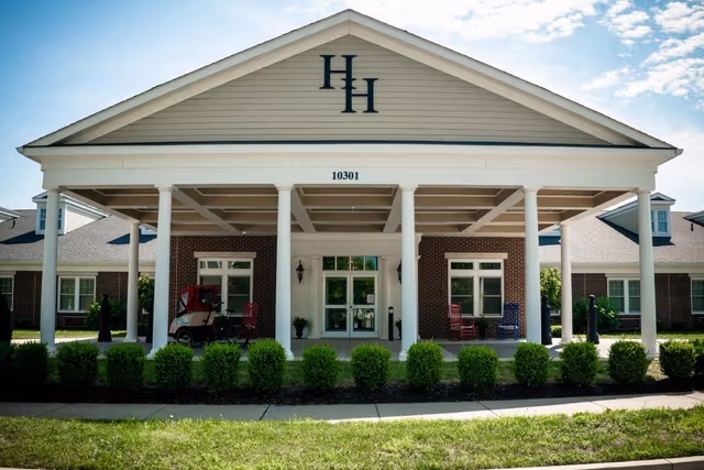 Front view of Hallmark House senior living facility with a covered entrance and columns.