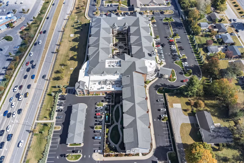 Aerial view of Legacy Reserve at Fritz Farm senior living campus with parking lots.
