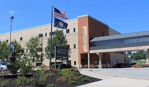 Exterior view of Rockcastle Regional Hospital and Respiratory Care with flags.