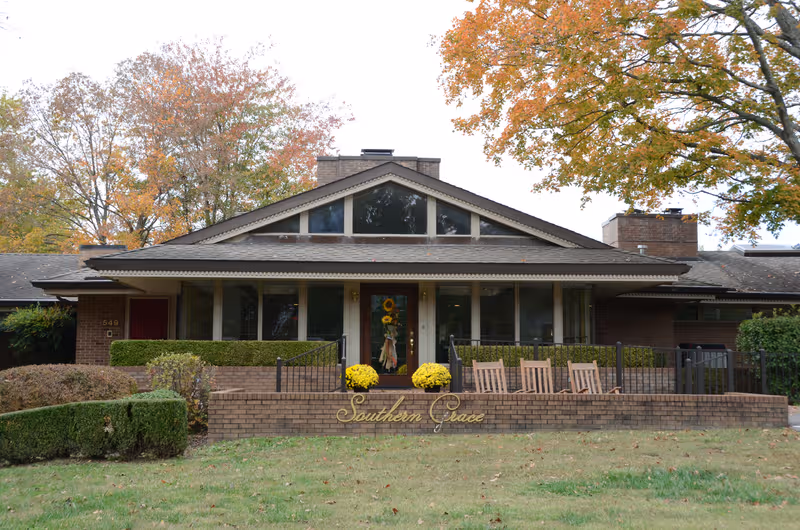 Front view of a brick senior living facility with a Southern Grace sign