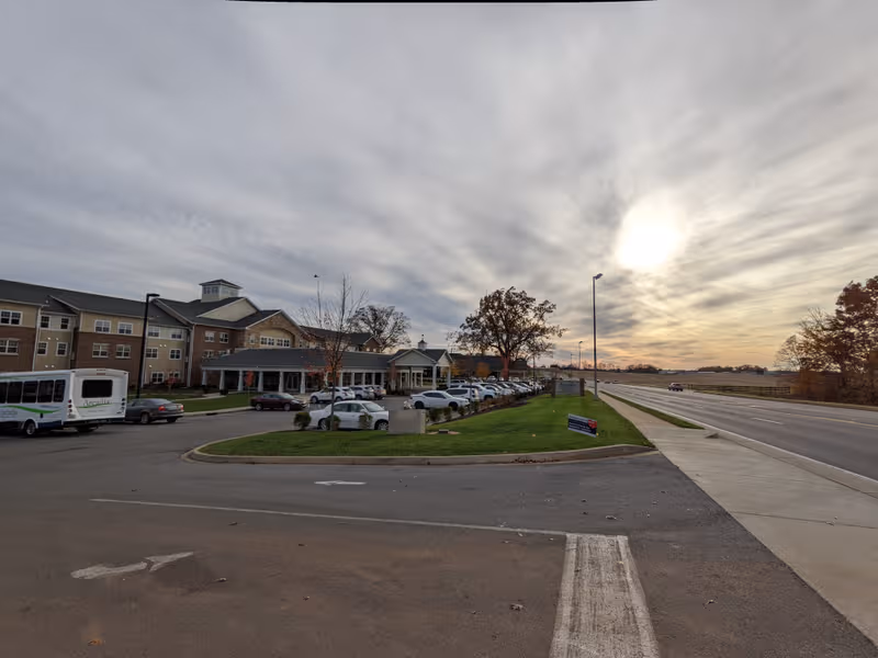 Exterior view of Arcadia Senior Living Bowling Green showing the building, parking lot, and entrance.
