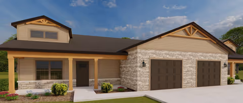 Exterior view of a single-story senior living facility with stone accents and a two-bay garage.