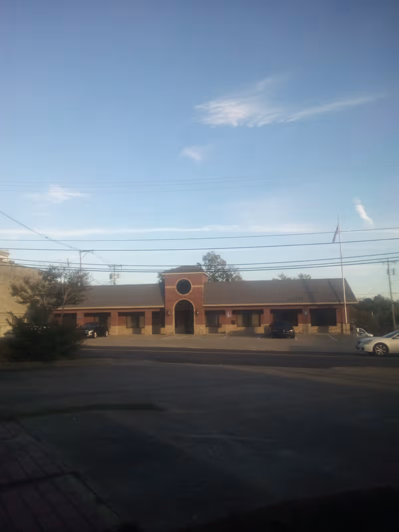 Salem Springlake Health and Rehab Center, brick single-story building with central arched entrance and circular window.