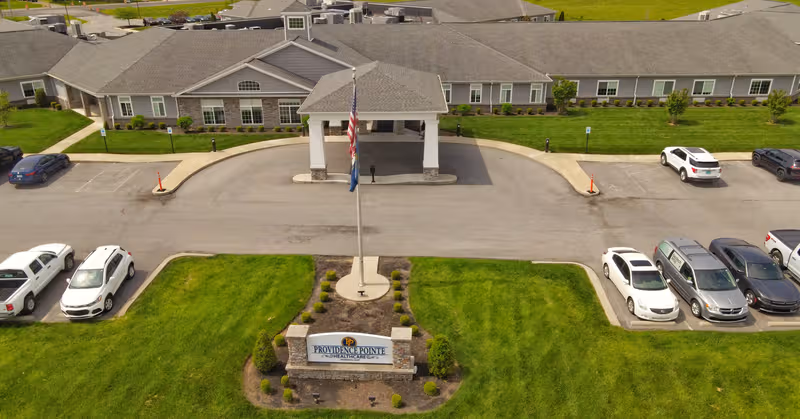 Aerial view of Providence Pointe Healthcare building with flagpole, entrance canopy, and parking.