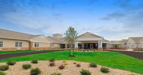 Front view of Westport Place Health Campus with green lawn, shrubs, and covered entrance.