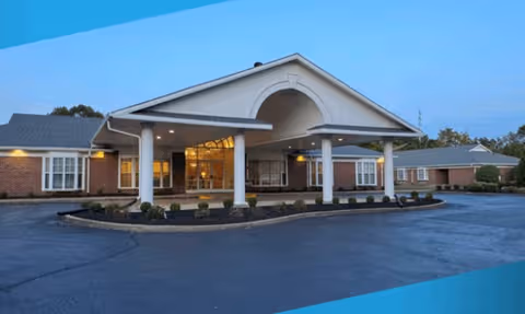 Front entrance of Wellington Parc of Owensboro senior living facility with covered drop-off