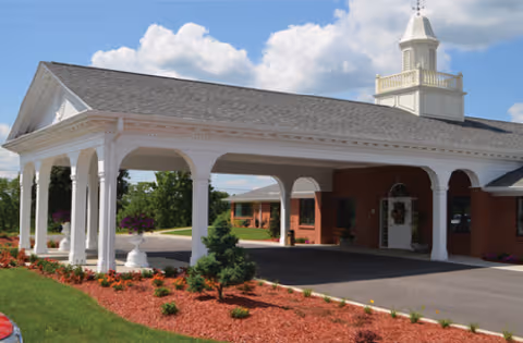 The porte-cochere has white columns at the Ridgeway Nursing & Rehab exterior.