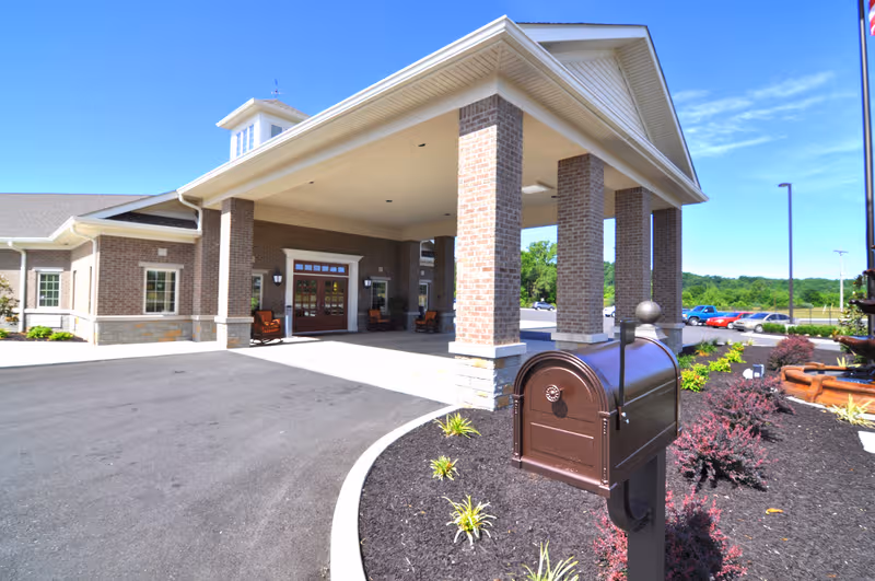 Exterior view of Barbourville Health and Rehabilitation Center entrance with brick columns.