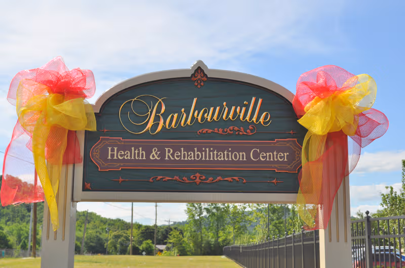 Front sign reads Barbourville Health & Rehabilitation Center with decorative bows.