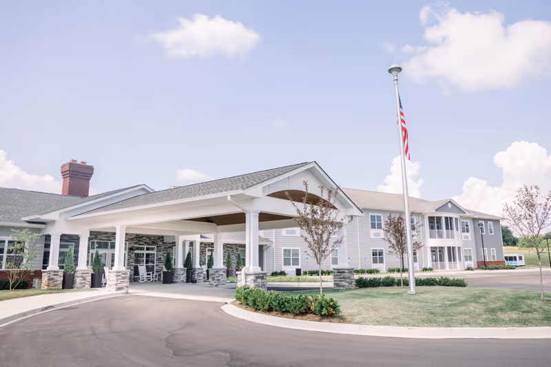 Front view of a modern senior living facility with a covered entrance.