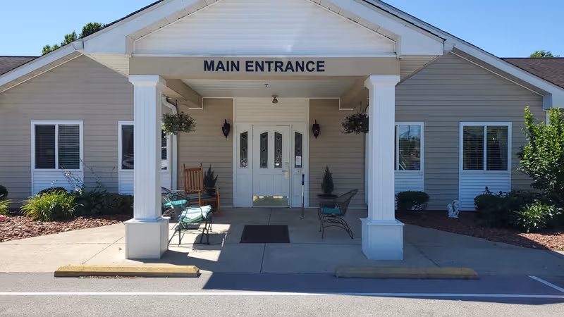 Single-story senior living facility with a covered entrance and white columns labeled Main Entrance.