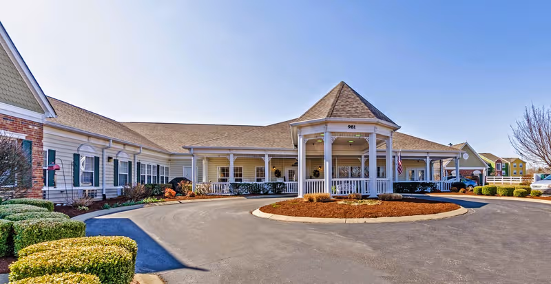Exterior view of The Bungalows at Bowling Green with a circular drive and covered entrance.