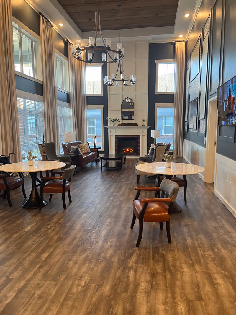 Spacious living room lounge at Signature HealthCARE of Elizabethtown with fireplace and seating.