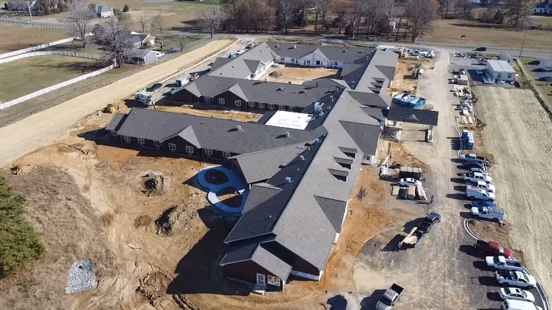 Aerial view of Charter Senior Living of Murray under construction with connected wings and parking.