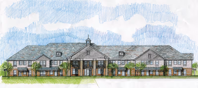 Architectural drawing of a two-story senior living facility building with a large central entrance featuring columns, multiple windows, and a pitched roof under a partly cloudy sky.
