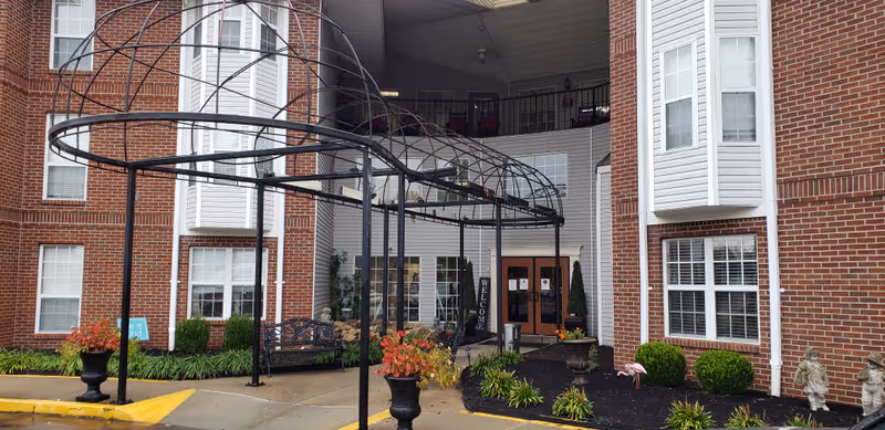 Exterior view of One Park Place entrance with circular metal canopy and landscaped entry.