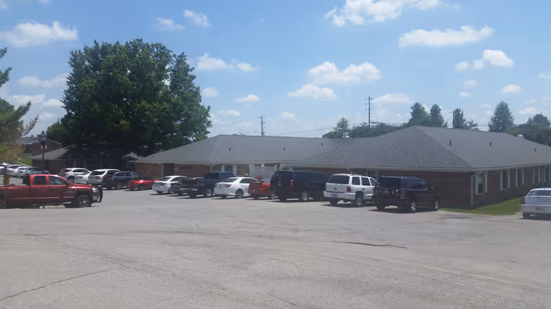 Exterior view of Madison Health & Rehabilitation Center with a parking lot.