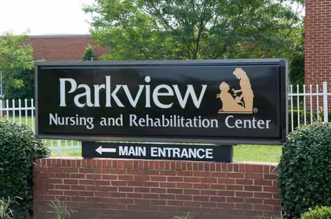 Parkview Nursing and Rehabilitation Center sign on brick wall at building entrance.