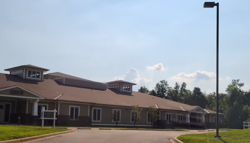 Single-story Radcliff Veterans Center building with brown roof along a curved driveway.