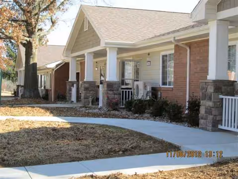 Exterior view of Greensburg Village senior living facility with porch columns.