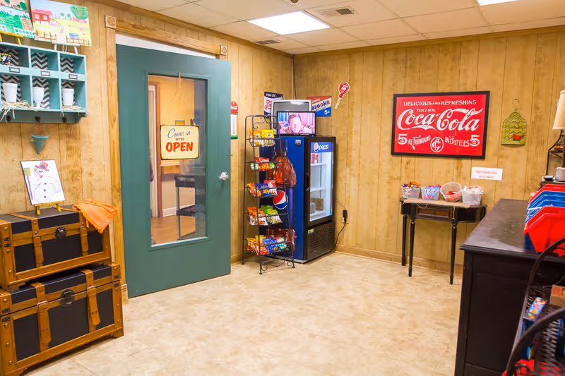 Interior common room at Pikeville Nursing and Rehab Center with vending machine and Coca-Cola sign.
