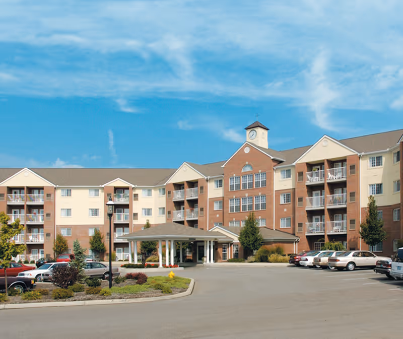 Exterior view of Barrington at Ft. Thomas senior living building with entrance and parking.