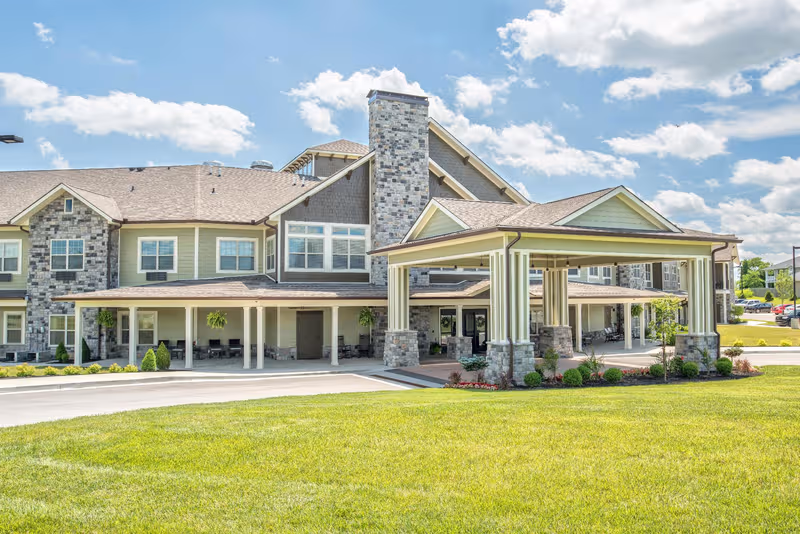 Senior living facility with stone facade and covered entrance at front.