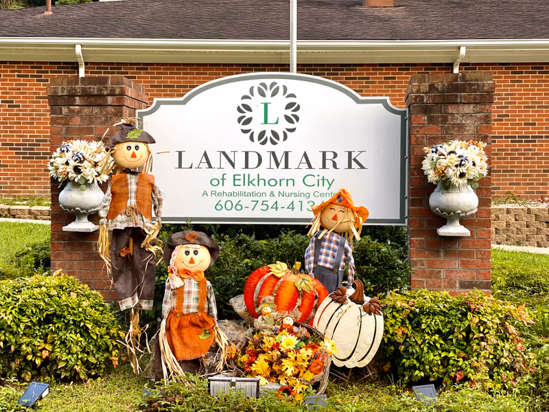 Exterior view of Landmark of Elkhorn City with autumn decorations and scarecrows.