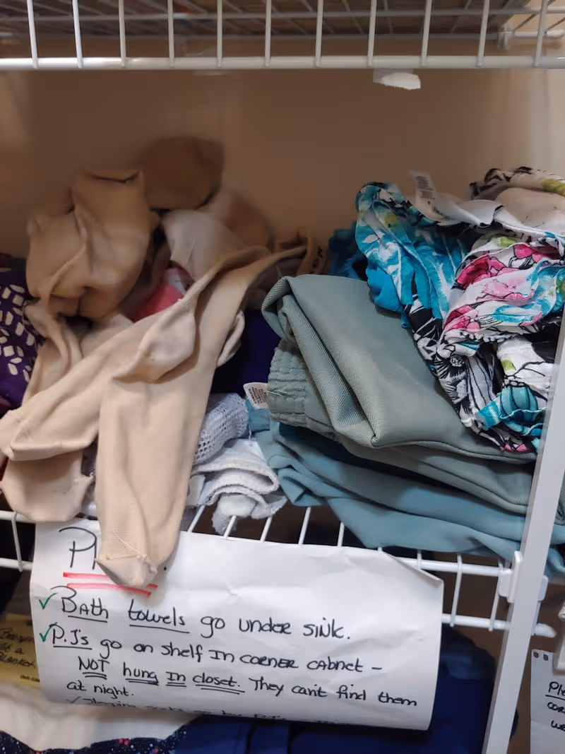 Closet wire shelf filled with folded towels and fabrics in a Morning Pointe Lexington-East facility.