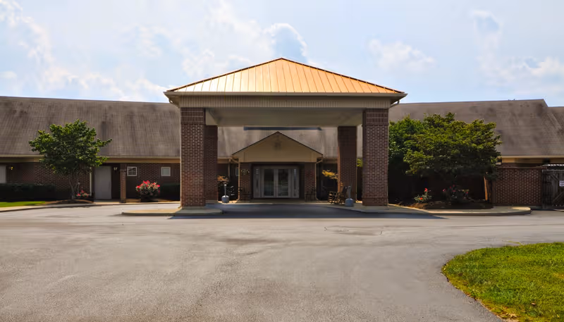Exterior view of The Neighborhood of Somerset entrance with brick columns and porte-cochère.