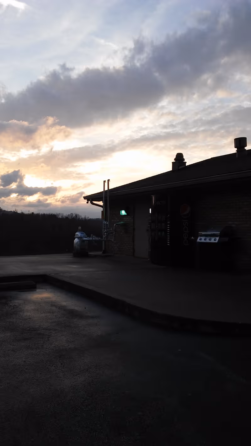This is an exterior view of a nursing home at dusk with vending machines outside.