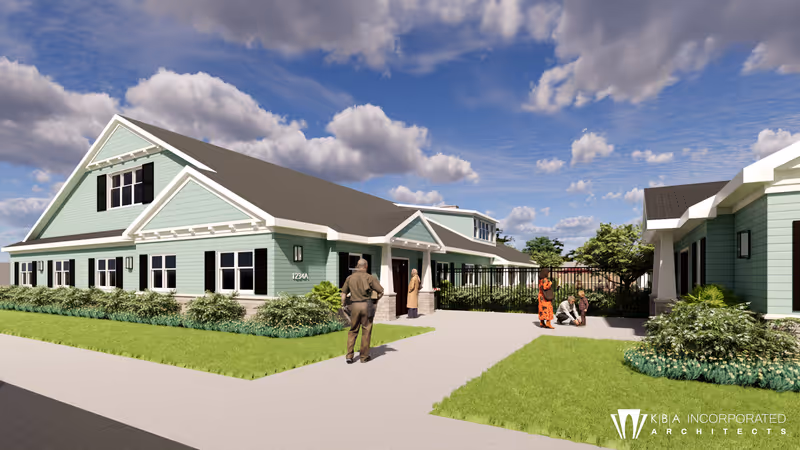 Exterior view of Honeysuckle House Assisted Living with residents near the entrance and landscaping.