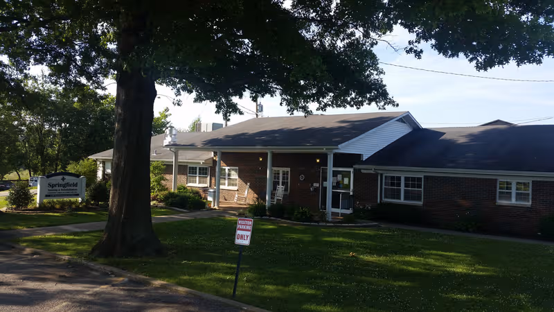 Single-story brick Springfield Nursing and Rehabilitation Center building with front entrance and manicured lawn.