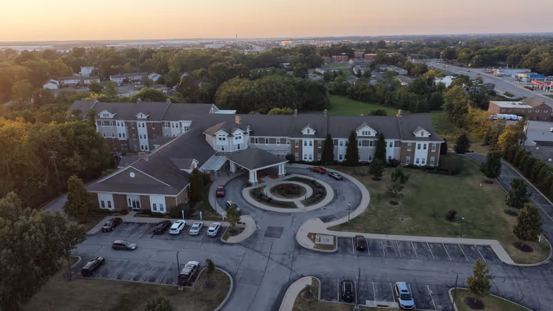 Aerial view of Fields of Florence senior living campus with circular driveway and parking.