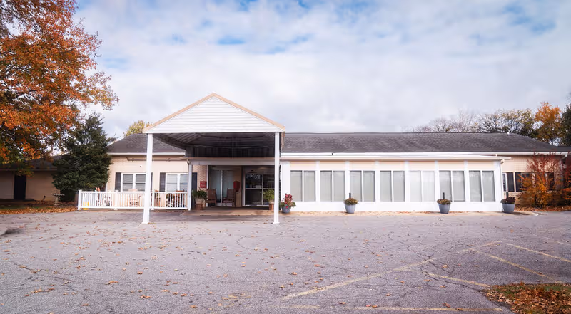Front exterior of Oakview Nursing and Rehabilitation Center showing a covered entrance and empty parking lot.