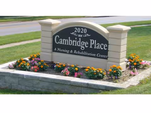Exterior Cambridge Place sign with a flower bed at the entrance.