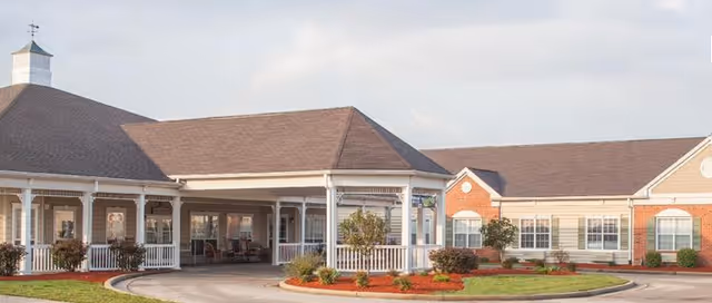 Wide view of Morning Pointe Owensboro exterior with a covered entrance and landscaped path.
