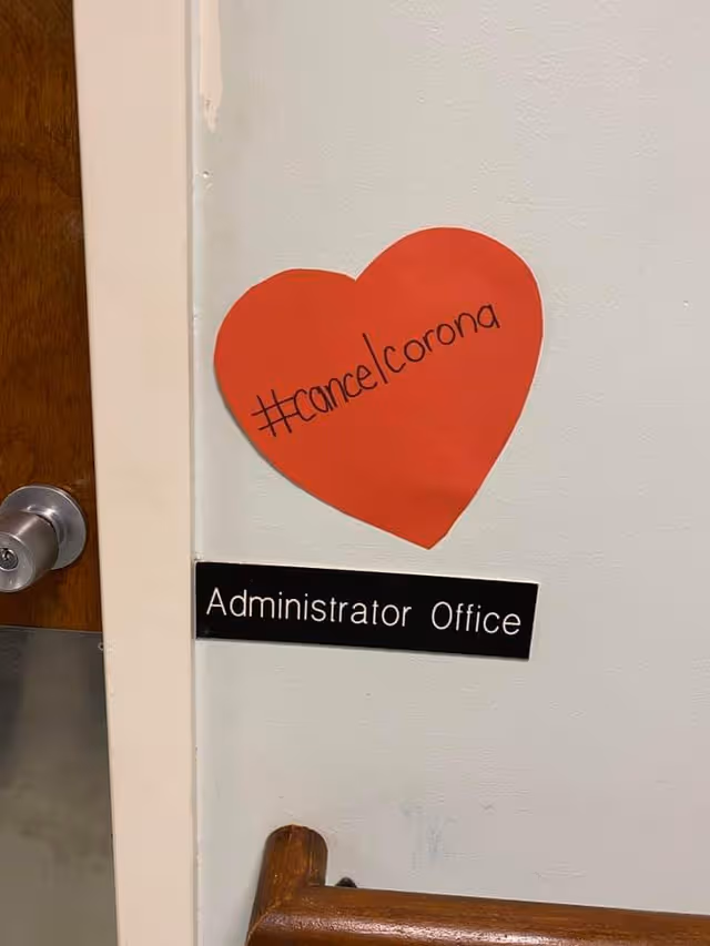 Interior wall shows a red heart sticker and an Administrator Office sign beside a door.
